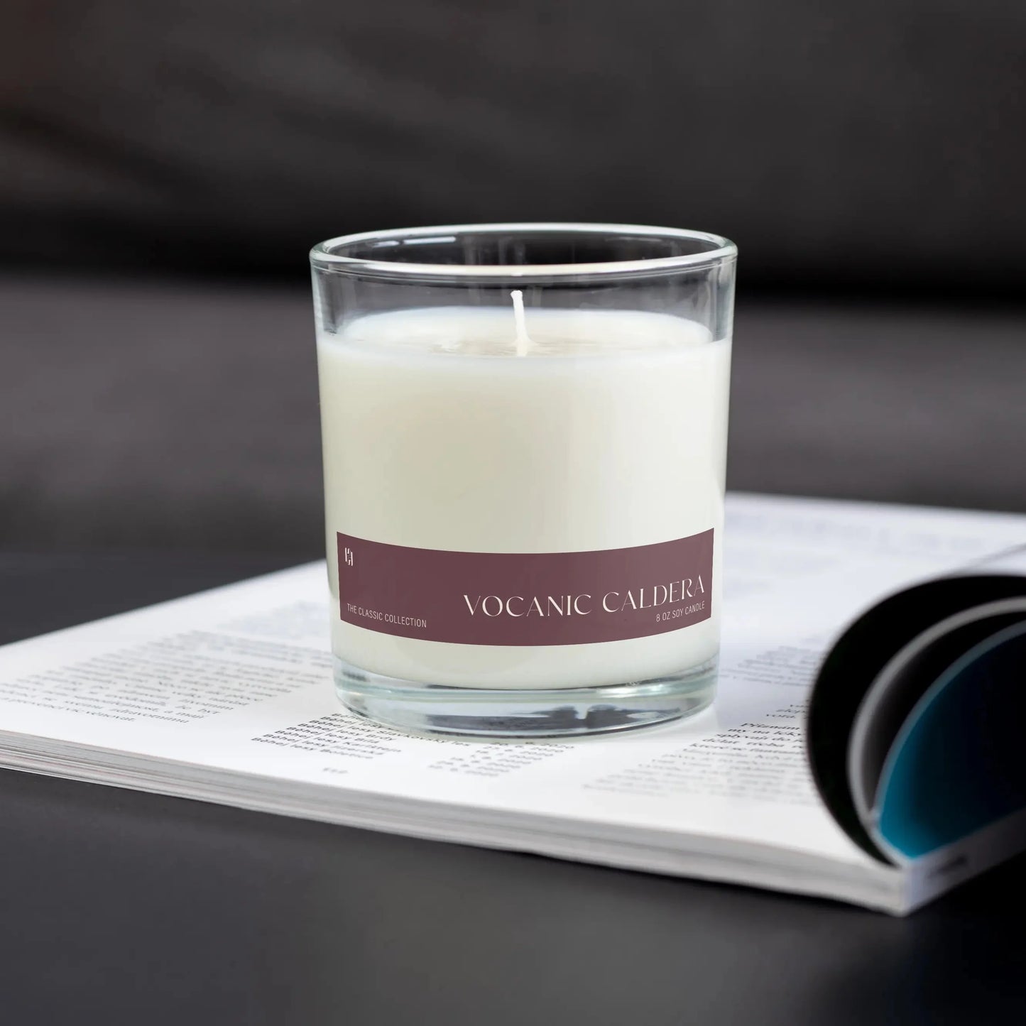 Candle with a purple label on an open magazine
