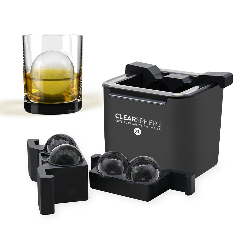 Clearsphere ice ball maker with spherical ice cubes and a glass of whiskey.