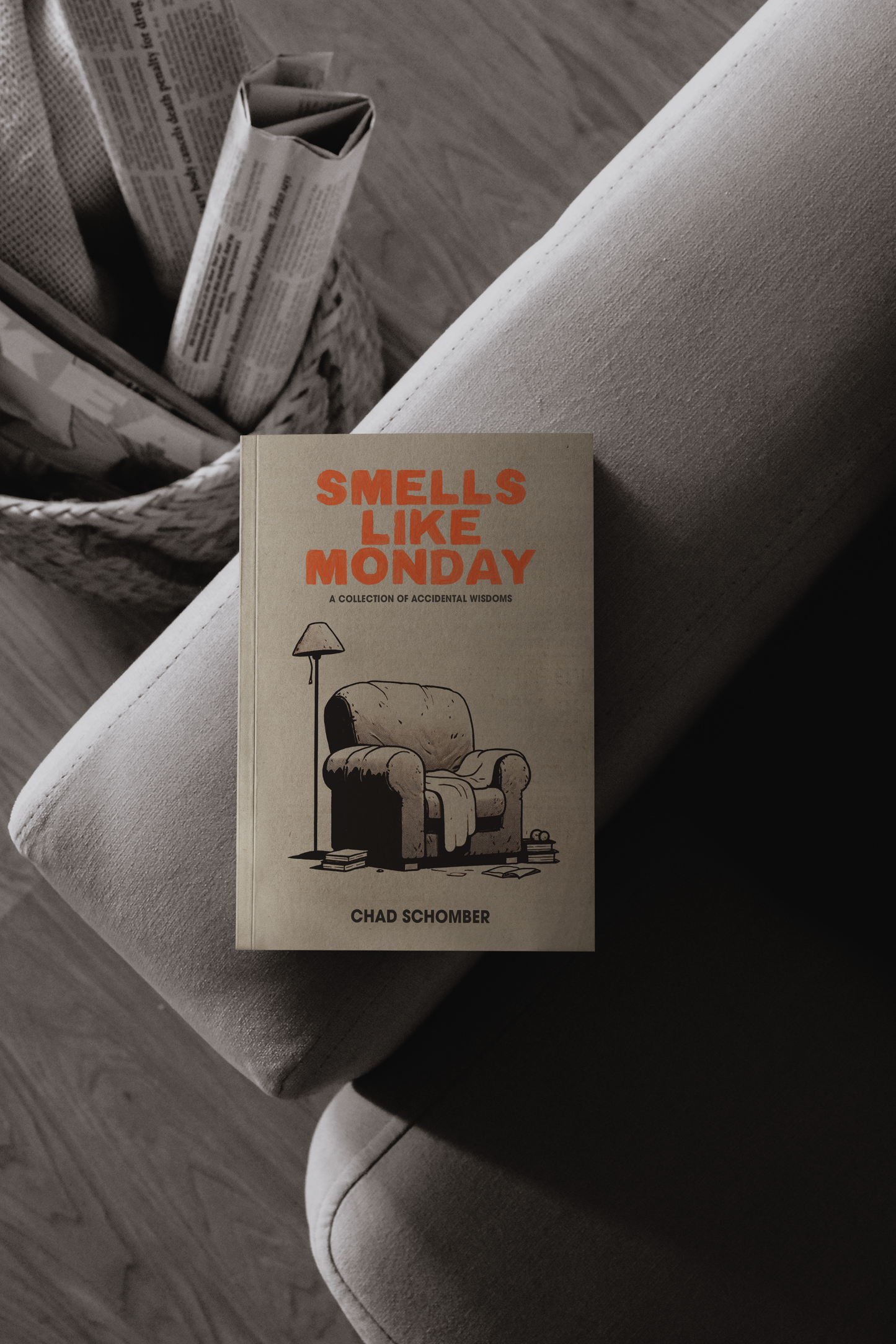 Smells Like Monday book on the armrest of a sofa. 