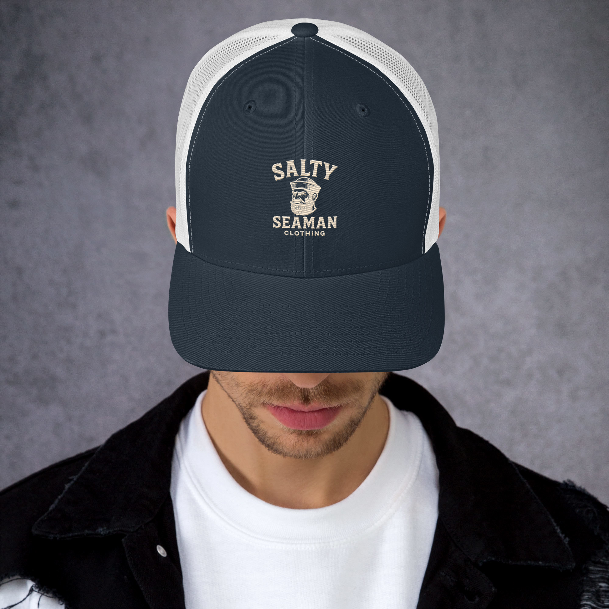 Person wearing a navy and white cap with 'Salty Seaman' branding against a gray background